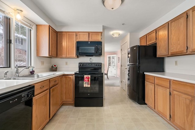 kitchen with sink and black appliances