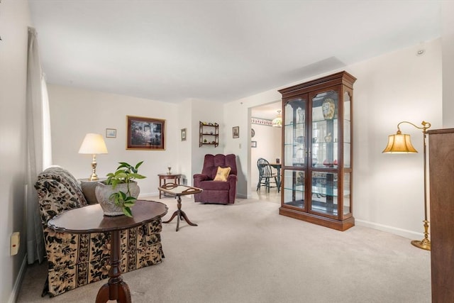 living area featuring light carpet