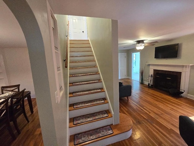 3 S Ter, Auburn, MA 01501 - stairs featuring arched walkways, a ceiling fan, wood finished floors, and a fireplace