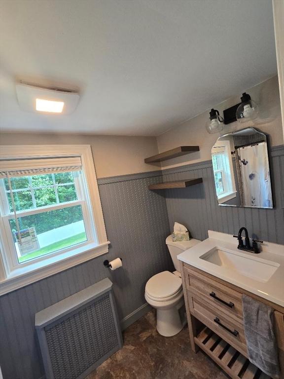 3 S Ter, Auburn, MA 01501 - bathroom featuring radiator, vanity, and a wainscoted wall