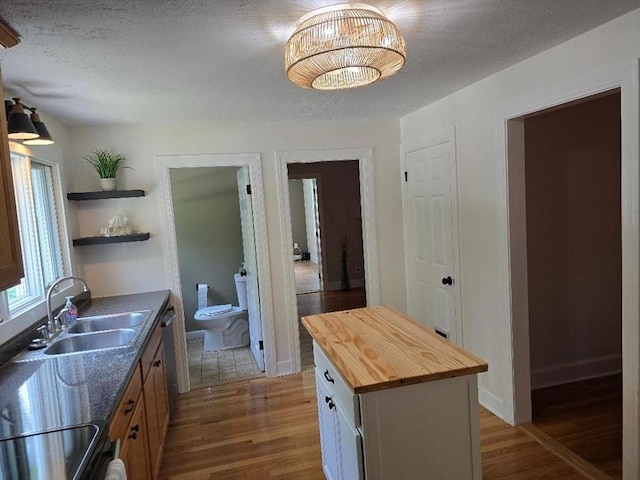 3 S Ter, Auburn, MA 01501 - kitchen featuring wooden counters, dark wood-style floors, open shelves, and a center island