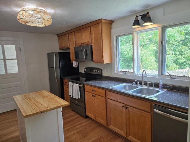 3 S Ter, Auburn, MA 01501 - kitchen featuring stainless steel appliances, butcher block counters, light wood finished floors, a textured ceiling, and brown cabinetry