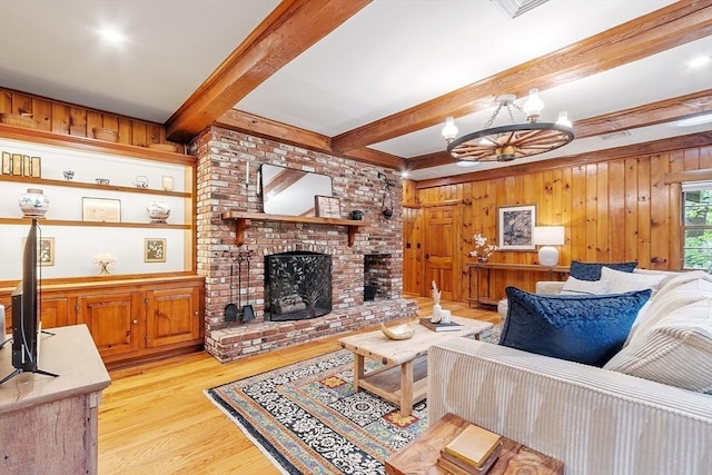 6 N St, Acton, MA 01720 - living area featuring beamed ceiling, wood walls, light wood-type flooring, a fireplace, and a chandelier