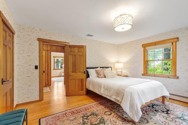 6 N St, Acton, MA 01720 - bedroom with light wood-type flooring, wallpapered walls, and baseboards
