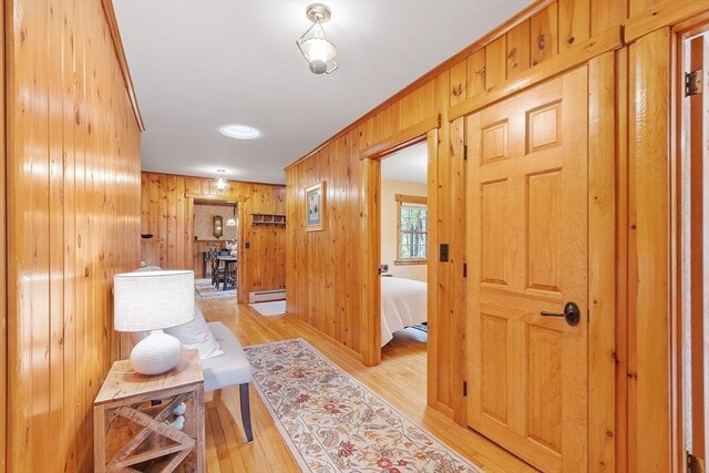 6 N St, Acton, MA 01720 - corridor featuring light wood-style flooring, wood walls, and a baseboard heating unit