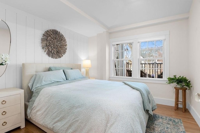 bedroom with baseboards and wood finished floors