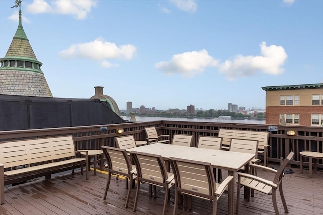4 Charlesgate E Unit 106, Boston, MA 02215 - wooden deck with a water view, outdoor dining area, and a city view