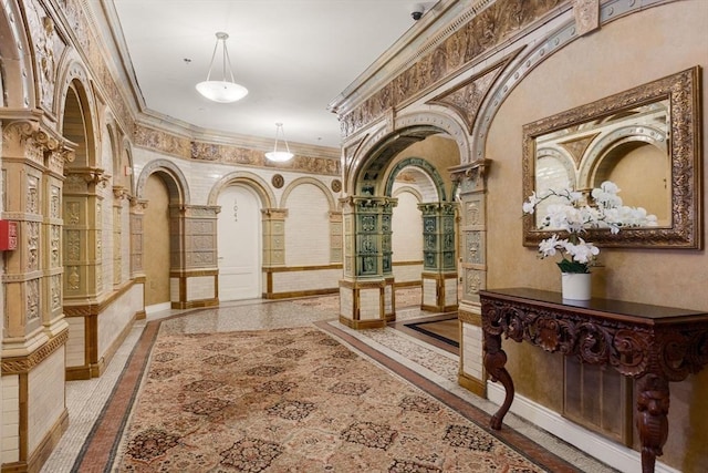 4 Charlesgate E Unit 106, Boston, MA 02215 - hall featuring inlaid floor details, crown molding, arched walkways, and ornate columns
