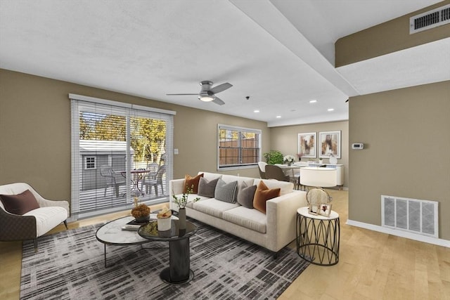 living room featuring ceiling fan and light wood-type flooring