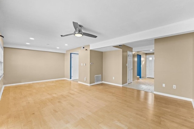 spare room featuring light hardwood / wood-style floors and ceiling fan