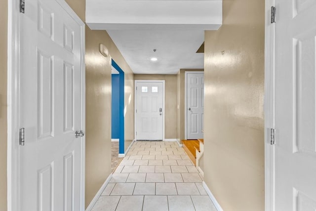 doorway featuring light tile patterned flooring