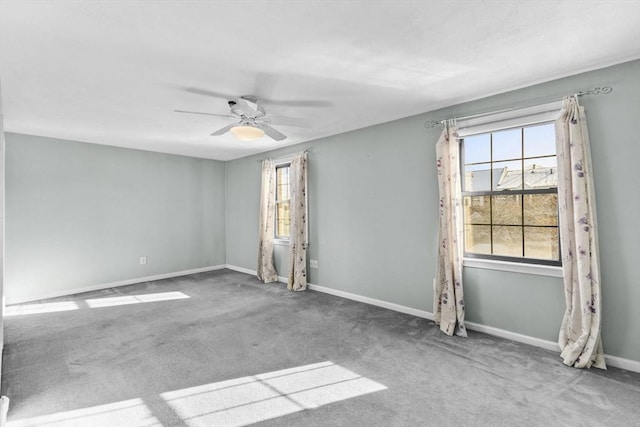 carpeted spare room with ceiling fan