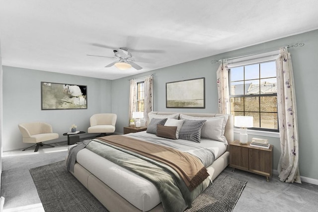 bedroom with multiple windows, carpet, and ceiling fan