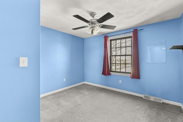 empty room featuring carpet floors and ceiling fan