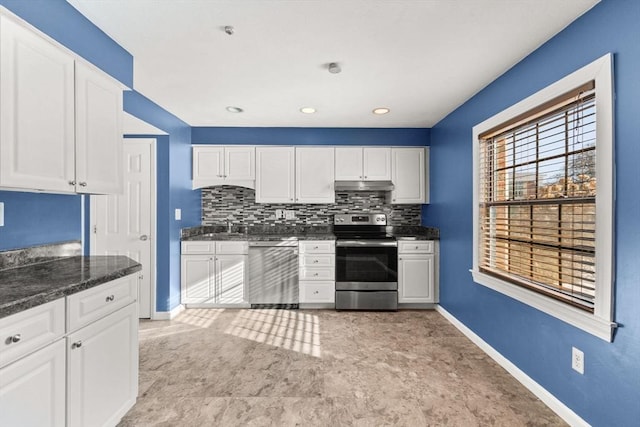 kitchen featuring stainless steel appliances, sink, white cabinets, and decorative backsplash