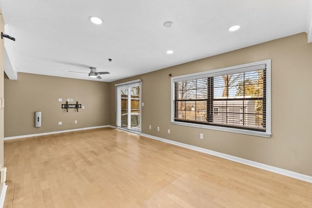 unfurnished room with ceiling fan, a healthy amount of sunlight, and light hardwood / wood-style flooring