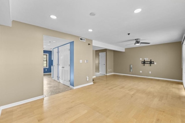 empty room with ceiling fan and light wood-type flooring