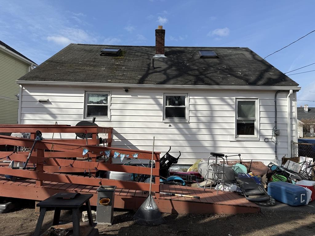 back of property with a chimney