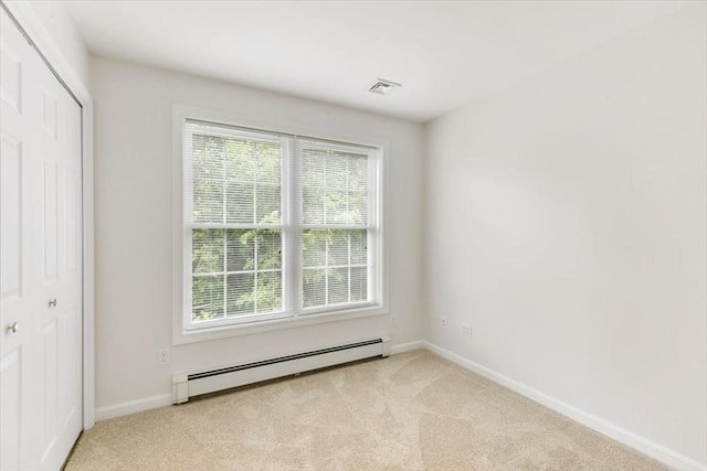 38 Abbey Rd Unit 38, Brentwood, NH 03833 - unfurnished bedroom featuring baseboard heating, multiple windows, and light colored carpet