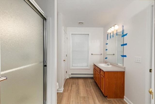 38 Abbey Rd Unit 38, Brentwood, NH 03833 - bathroom featuring a baseboard radiator, vanity, wood finished floors, and a shower stall