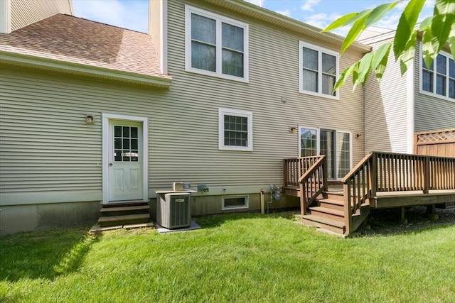 38 Abbey Rd Unit 38, Brentwood, NH 03833 - back of property featuring entry steps, a wooden deck, a lawn, and a shingled roof