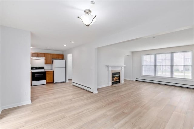 38 Abbey Rd Unit 38, Brentwood, NH 03833 - unfurnished living room featuring baseboard heating, a tiled fireplace, light wood-style flooring, and recessed lighting