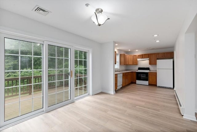 38 Abbey Rd Unit 38, Brentwood, NH 03833 - kitchen featuring white appliances, baseboard heating, light countertops, light wood-style floors, and recessed lighting