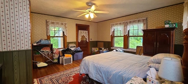 293 Cocasset St, Foxboro, MA 02035 - bedroom featuring wainscoting, crown molding, wood finished floors, wallpapered walls, and a ceiling fan
