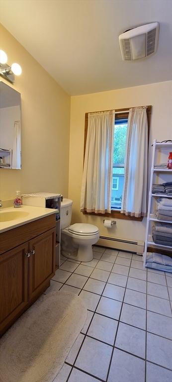 293 Cocasset St, Foxboro, MA 02035 - bathroom featuring a baseboard heating unit, vanity, and tile patterned flooring