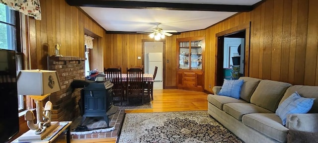 293 Cocasset St, Foxboro, MA 02035 - office area with light wood finished floors, beam ceiling, wooden walls, ceiling fan, and a wood stove