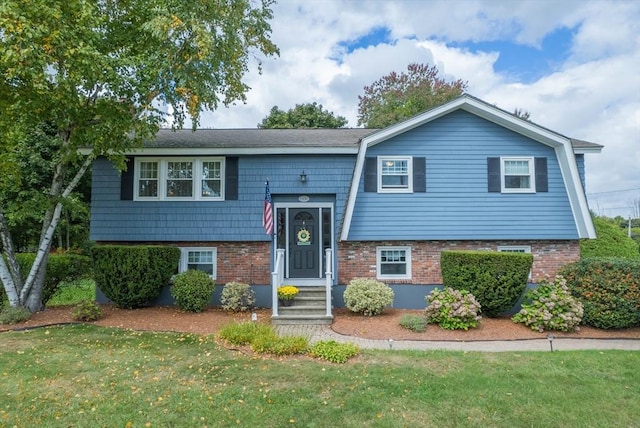 1550 Andover St, Tewksbury, MA 01876 - raised ranch with a front lawn and brick siding