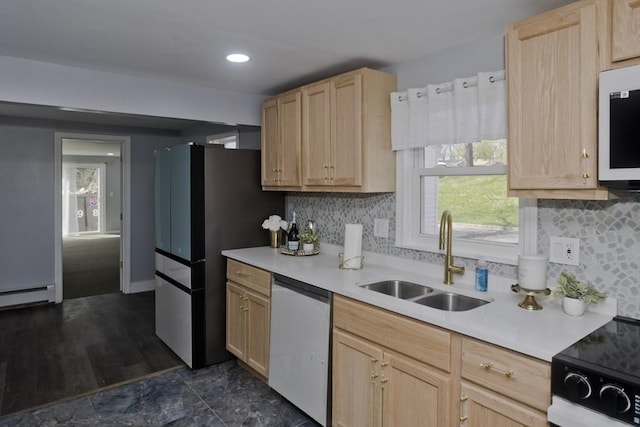 kitchen featuring light brown cabinetry, light countertops, tasteful backsplash, a sink, and stainless steel appliances