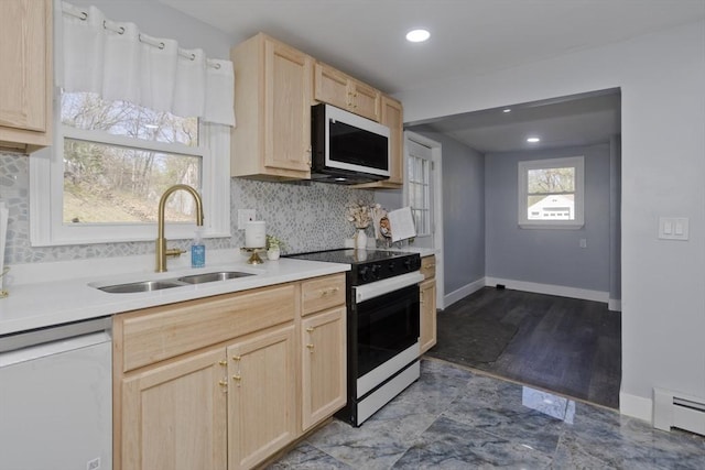 kitchen with light brown cabinetry, range with electric stovetop, dishwashing machine, white microwave, and a sink