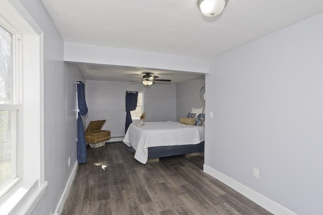 bedroom featuring baseboards, ceiling fan, and wood finished floors