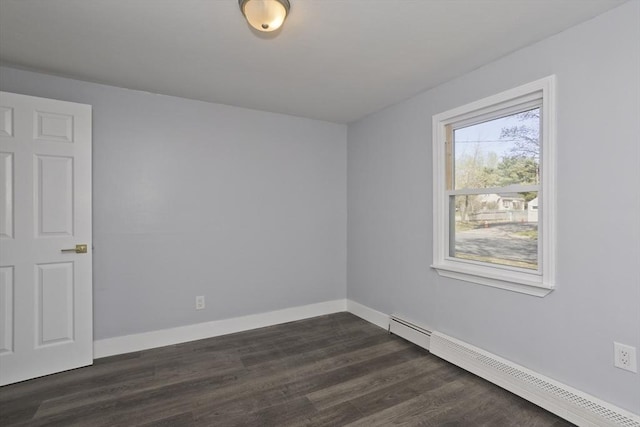 unfurnished room with baseboards, dark wood-style floors, and baseboard heating