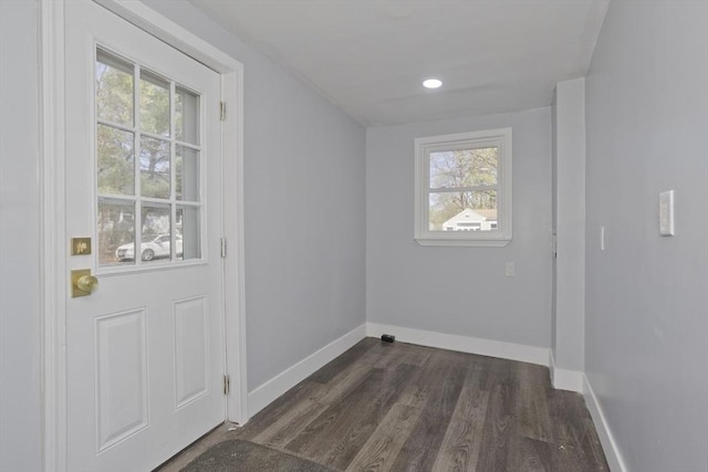 entryway featuring baseboards, a wealth of natural light, and dark wood-style floors