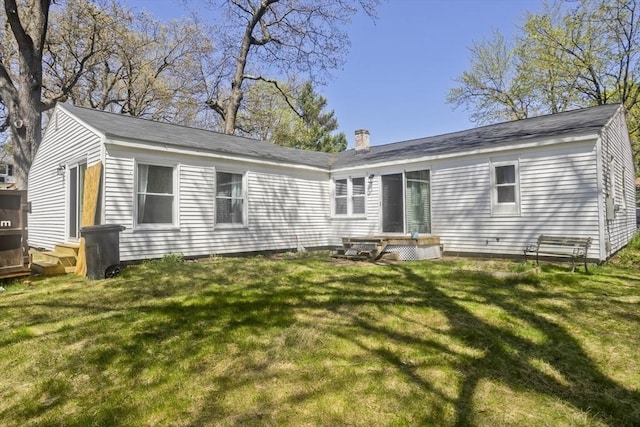 rear view of property featuring a yard and entry steps