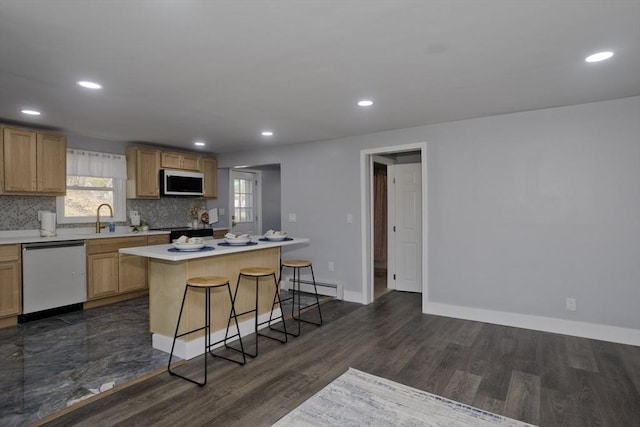 kitchen featuring a baseboard radiator, a sink, dishwasher, light countertops, and white microwave
