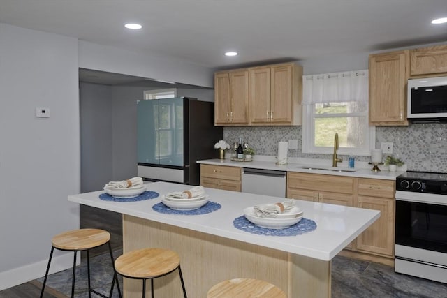 kitchen featuring electric range oven, dishwasher, a sink, white microwave, and freestanding refrigerator
