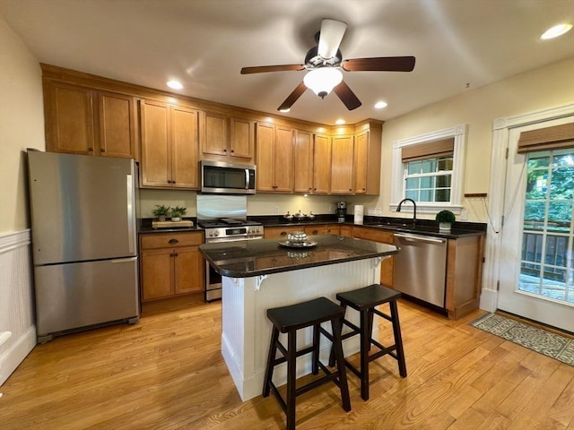 36-1/2 Pearl St Unit 36H, Milford, MA 01757 - kitchen featuring appliances with stainless steel finishes, light wood-style flooring, a breakfast bar, a kitchen island, and recessed lighting