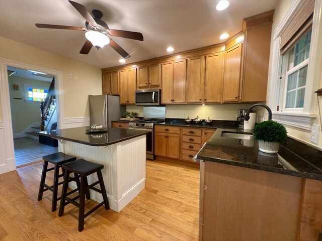 36-1/2 Pearl St Unit 36H, Milford, MA 01757 - kitchen featuring stainless steel appliances, a kitchen breakfast bar, light wood-style flooring, a center island, and recessed lighting