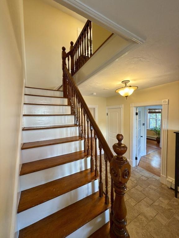 36-1/2 Pearl St Unit 36H, Milford, MA 01757 - stairs with stone tile floors and baseboards