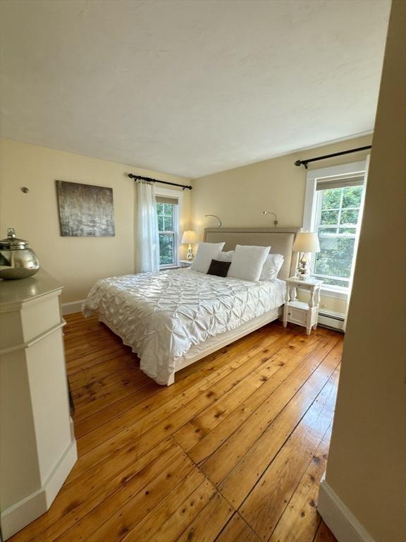 36-1/2 Pearl St Unit 36H, Milford, MA 01757 - bedroom with wood-type flooring and baseboards