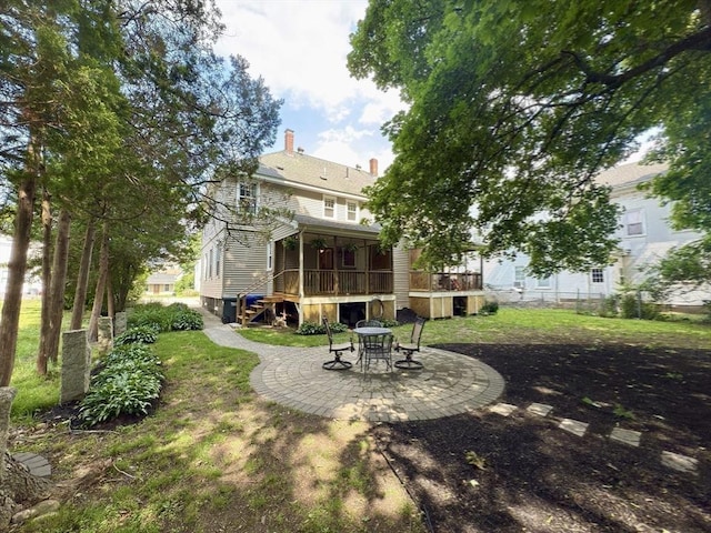 36-1/2 Pearl St Unit 36H, Milford, MA 01757 - back of house with a patio area, a deck, a chimney, and a lawn