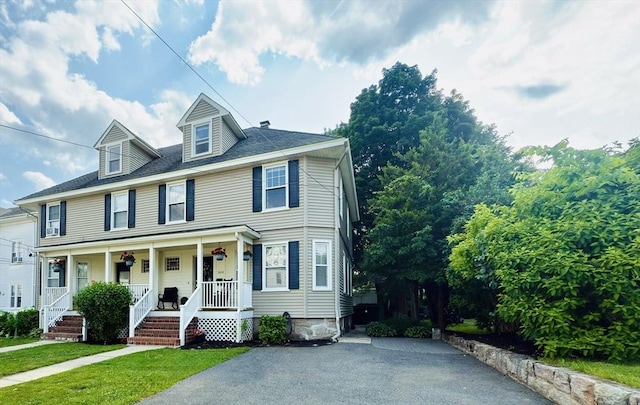 36-1/2 Pearl St Unit 36H, Milford, MA 01757 - view of front facade featuring covered porch, asphalt driveway, and a front yard