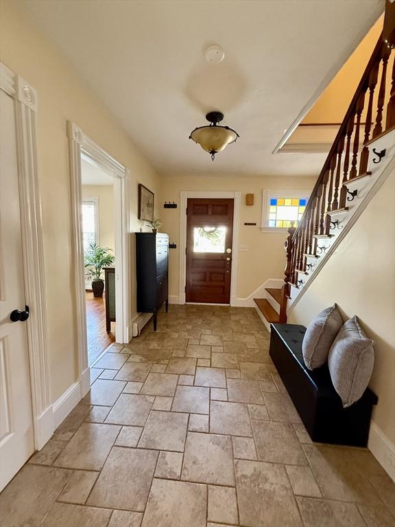 36-1/2 Pearl St Unit 36H, Milford, MA 01757 - entrance foyer with stone tile floors and stairway
