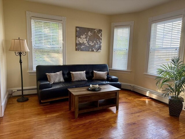 36-1/2 Pearl St Unit 36H, Milford, MA 01757 - living area with a baseboard heating unit, hardwood / wood-style flooring, and plenty of natural light