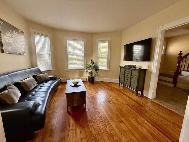 36-1/2 Pearl St Unit 36H, Milford, MA 01757 - living room featuring stairway, wood finished floors, and a baseboard heating unit