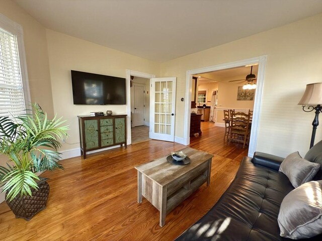 36-1/2 Pearl St Unit 36H, Milford, MA 01757 - living room with wood finished floors, ceiling fan, and french doors