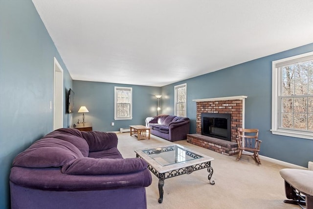 living area featuring carpet flooring, a fireplace, baseboard heating, and baseboards